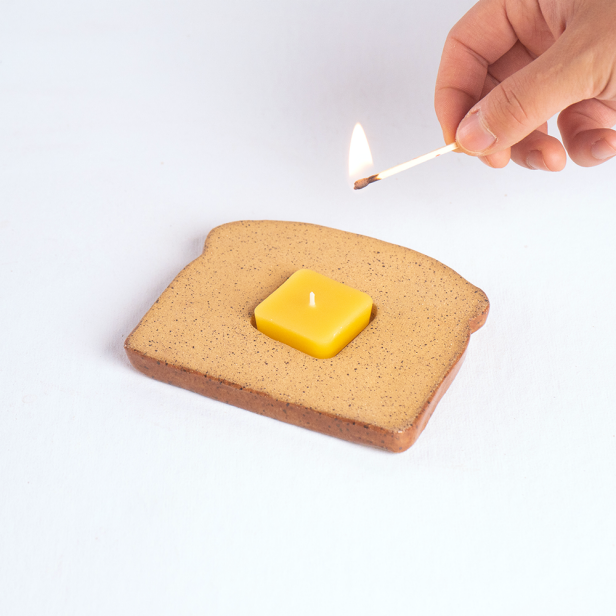 https://food.fnr.sndimg.com/content/dam/images/food/products/2023/11/15/rx_ceramic-toast-candle.png.rend.hgtvcom.616.616.suffix/1700062744443.png