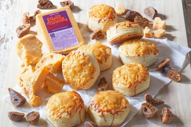 Trader Joe's Figgy Cheddar shown baked on top of Organic Biscuits; chunks of cheese and dried figs surrounding
