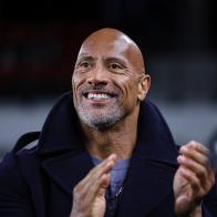 WASHINGTON, DC - FEBRUARY 19: (L-R) XFL owner Dwayne Johnson reacts on the sideline during the first half of the XFL game between the DC Defenders and the Seattle Sea Dragons at Audi Field on February 19, 2023 in Washington, DC. (Photo by Scott Taetsch/Getty Images)between the DC Defenders and the Seattle Sea Dragons