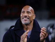 WASHINGTON, DC - FEBRUARY 19: (L-R) XFL owner Dwayne Johnson reacts on the sideline during the first half of the XFL game between the DC Defenders and the Seattle Sea Dragons at Audi Field on February 19, 2023 in Washington, DC. (Photo by Scott Taetsch/Getty Images)between the DC Defenders and the Seattle Sea Dragons