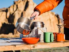 Redmond, OR , USA - December , 03, 2021: A camper pours boiling water from a pot while making breakfast on a frost covered picnic table at Smith Rock State Park on December 3, 2021.
(Photo by Alex Ratson via Getty Images)