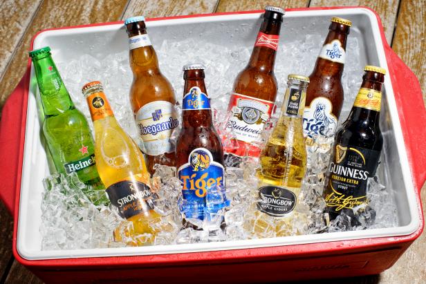 Various beer bottles with different brand in an ice container