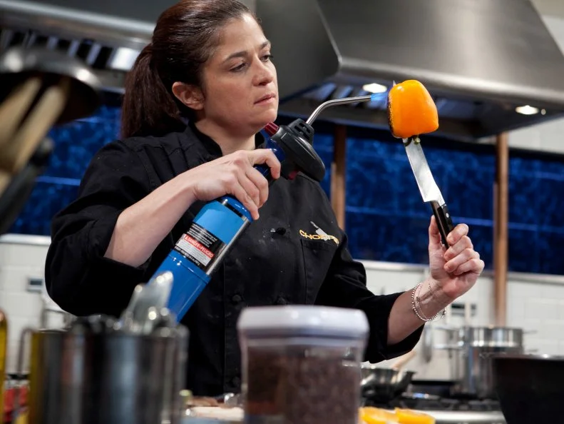 Chopped: After Hours chef Alex Guarnaschelli working on her dessert that must include: vanilla pudding cups, wafer sheets, lemon soda and a torch, as seen on Food Network's Chopped: After Hours.