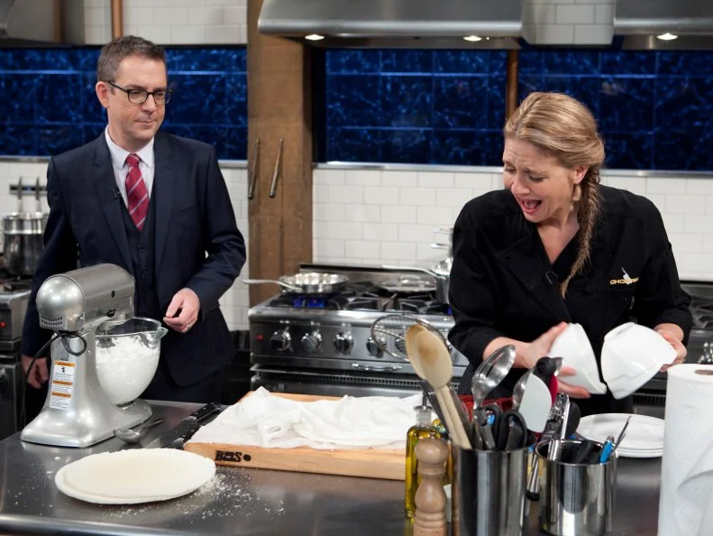 Chopped: After Hours host Ted Allen talks with chef Amanda Freitag while she works on her dessert that must include: vanilla pudding cups, wafer sheets, lemon soda and a torch, as seen on Food Network's Chopped: After Hours.