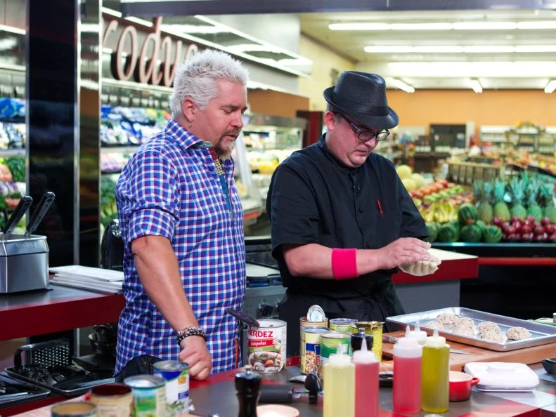 Host Guy Fieri with chef Daniel Vercher during the cooking part of Game 1, Can Can, Italian Feast, 30 min time limit, as seen on Food Network's Guy's Grocery Games, Season 1.