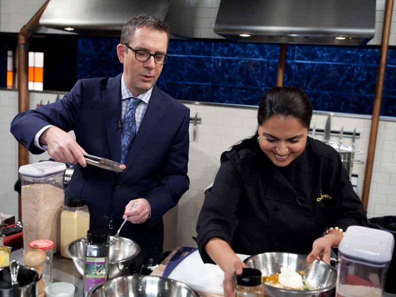 Chopped: After Hours host Ted Allen pulls a knuckle bone from Maneet Chauhan's pickled pigs feet while she works on her appetizer that must include: pickled pigs feet, butter beans, coleslaw mix and sweet potato chips, as seen on Food Network's Chopped: After Hours.