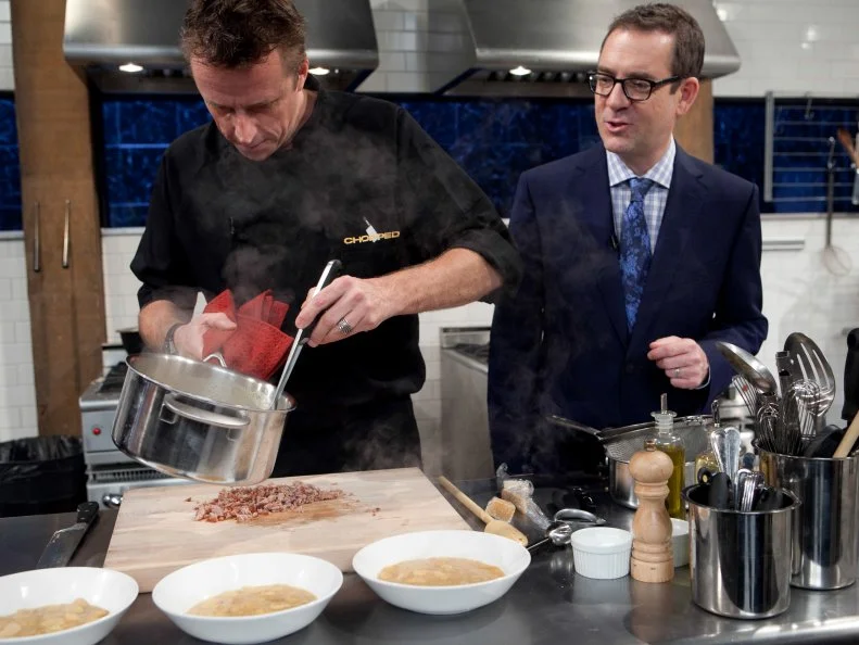 Chopped: After Hours host Ted Allen talks with chef Marc Murphy while he works on his appetizer that must include: pickled pigs feet, butter beans, coleslaw mix and sweet potato chips, as seen on Food Network's Chopped: After Hours.