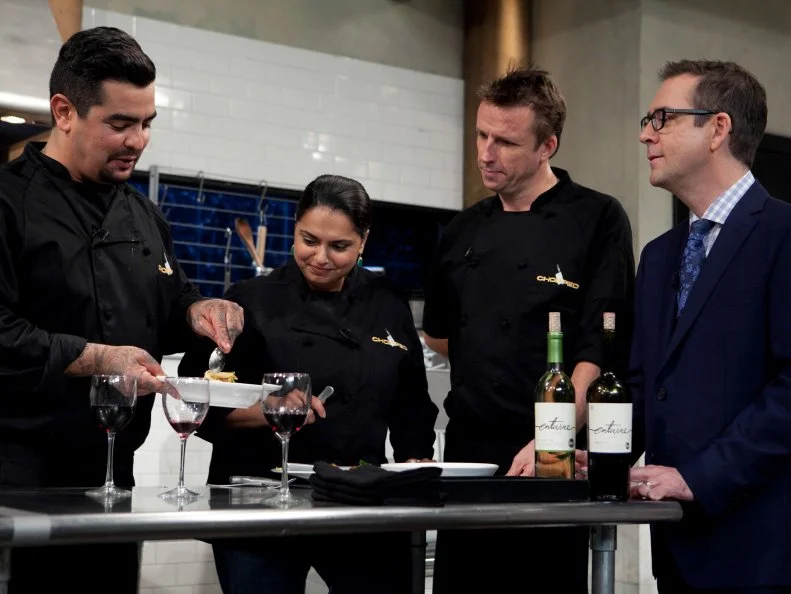 Chopped: After Hours host Ted Allen and chefs: Aaron Sanchez, Maneet Chauhan and Marc Murphy taste their appetizers that must have included: pickled pigs feet, butter beans, coleslaw mix and sweet potato chips, as seen on Food Network's Chopped: After Hours.