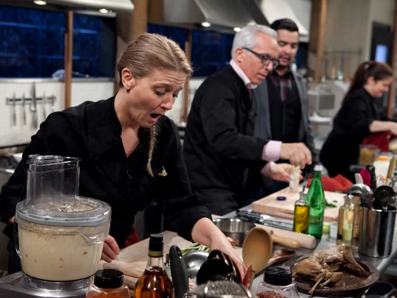 Chopped: After Hours host Aaron Sanchez talks to chef Geoffrey Zakarian while he and chefs Amanda Freitag and Alex Guarnaschelli work on their entrees that must include: deep dish pizza dough, rabbit escabeche, swiss chard and pineapple cheese spread, as seen on Food Network's Chopped: After Hours.