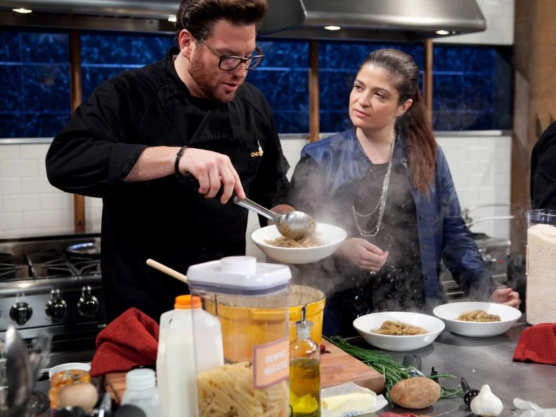 Chopped: After Hours host Alex Guarnaschelli checks in chef Scott Conant while he is working on his entree that must include: tikka masala sauce, Asian long beans, hanger steak and croquettes, as seen on Food Network's Chopped: After Hours.