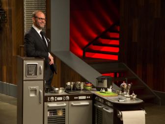 Host Alton Brown auctions off Round 3 sabotage element of the Superstar Sabotage Tournament Finale, Mini Kitchen, as seen on Food Network's Cutthroat Kitchen, Season 5.