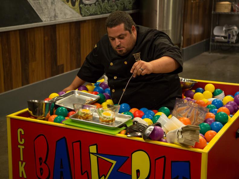 Chef Eric Greenspan, plates his dish, Spaghetti and Meatballs Asian Style, in Round 1 sabotage element, Ball-Pit Prep Station, as seen on Food Network's Cutthroat Kitchen, Season 5.