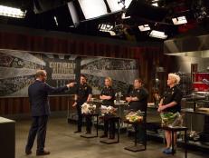 Host Alton Brown auctions off sabotage element, Protein Swap, during Round 1, as seen on Food Network's Cutthroat Kitchen, Season 5.