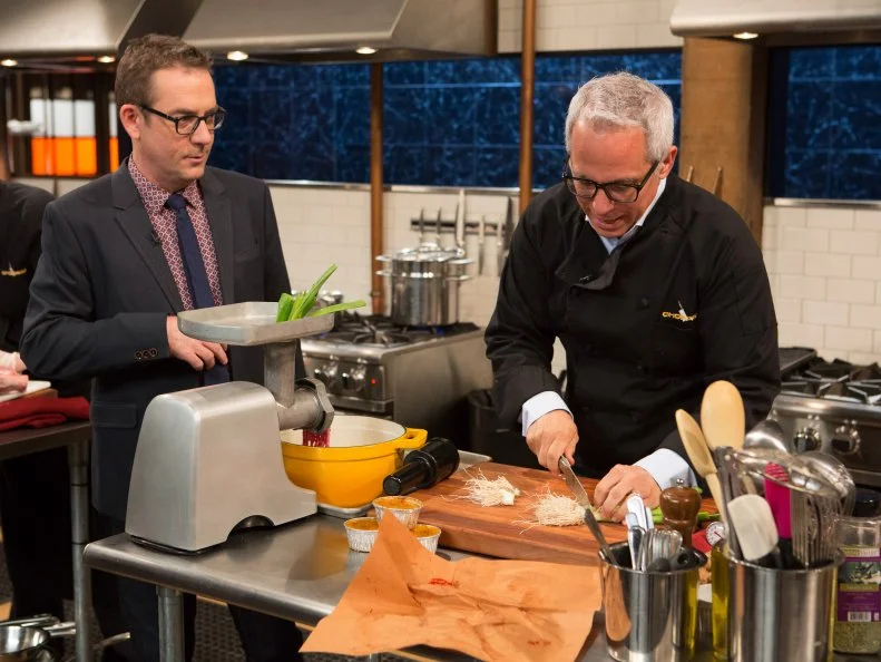 Chopped After Hours host Ted Allen chats with chef Geoffrey Zakarian while he works on his dish that must include: lamb shank, ginger, baby leeks and creme brulee, as seen on Food Network's Chopped After Hours, Season 22.