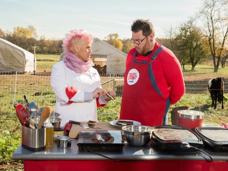 Hosts Anne Burrell talks with contestant Benji Brown during a cooking challenge on Cherry Grove Farm as seen on Food Networkâ  s Worst Cooksin America, Season 5.
