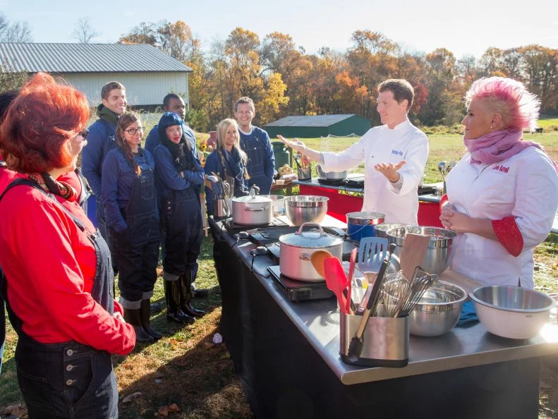 Cast members watch as hosts Anne Burrell and Bobby Flay demonstrate cooking  on Cherry Grove Farm as seen on Food Networkâ  s Worst Cooksin America, Season 5.