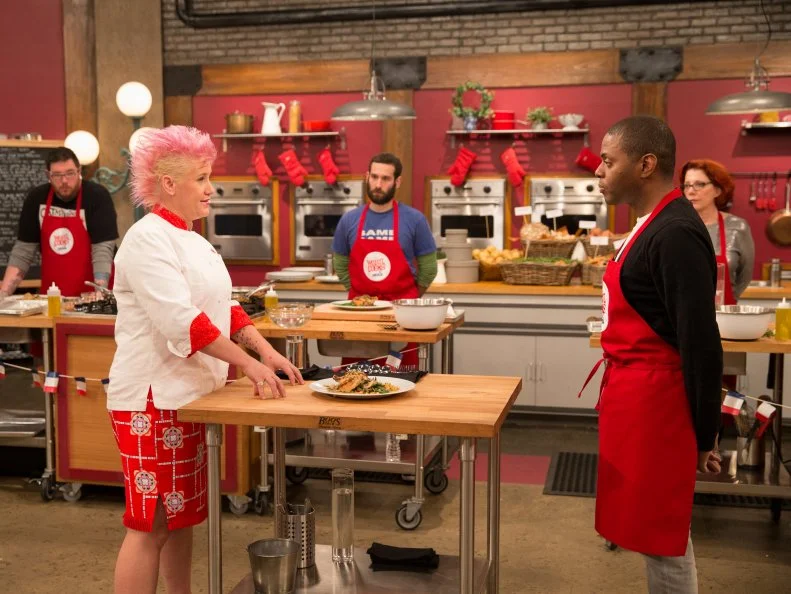 Host Anne Burrell (l) assesses the cooking of contestant Jamie Thomas on set as seen on Food Networkâ  s Worst Cooksin America, Season 5.
