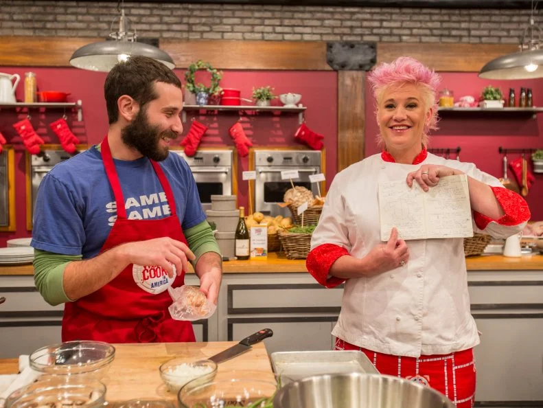 Host Anne Burrell makes fun of the notebook of  contestant Mike Glazer as he cooks as seen on Food Networkâ  s Worst Cooksin America, Season 5.