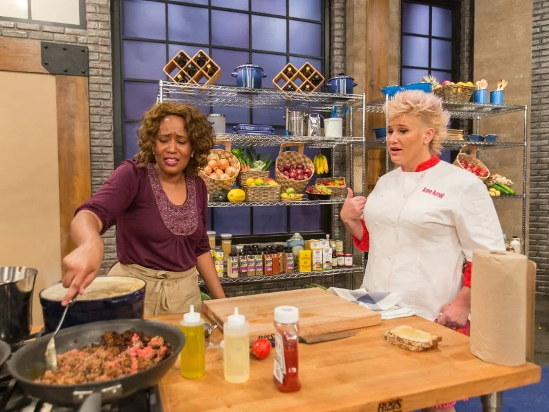 Chef Anne Burrell looks on as cast member Muneerah Warner complains as seen on Food Networkâ  s Worst Cooks in America, Season 5.