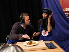 The Blue Team, Daniel Beyda and Amber Brauner, try to determine the ingredients and flavors of their Halibut with Endive and Gremolata, during the Remote Control Skill Drill. They have to direct Blue Team Leader Chef Bobby Flay via headset to make the same dish they are seeing for the first time, as seen on Food Network's Worst Cooks in America, Season 5.