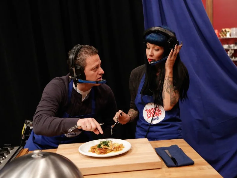 The Blue Team, Daniel Beyda and Amber Brauner, try to determine the ingredients and flavors of their Halibut with Endive and Gremolata, during the Remote Control Skill Drill. They have to direct Blue Team Leader Chef Bobby Flay via headset to make the same dish they are seeing for the first time, as seen on Food Network's Worst Cooks in America, Season 5.
