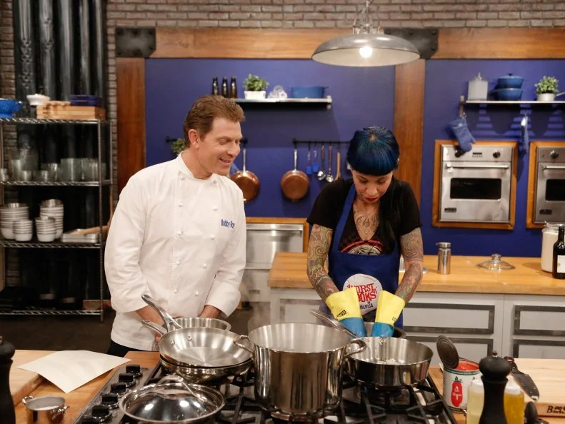 Blue Team Leader Chef Bobby Flay looks on as Blue Team recruit Amber Brauner begins preparing her dish for her loved one in the Feed the Family Challenge. Blue Team recruit Amber Brauner has to prepare Blue Team Leader Chef Bobby's Chicken Parmesan, as seen on Food Network's Worst Cooks in America, Season 5.