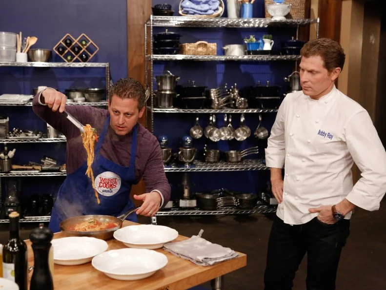 Blue Team recruit Daniel Beyda races to complete his dish  for his loved one as Blue Team Leader Chef Bobby Flay looks on, during the Feed the Family Challenge. Blue Team recruit Daniel Beyda has to prepare Blue Team Leader Chef Bobby Flay's Spaghetti & Meatballs with Ricotta, as seen on Food Network's Worst Cooks in America, Season 5.