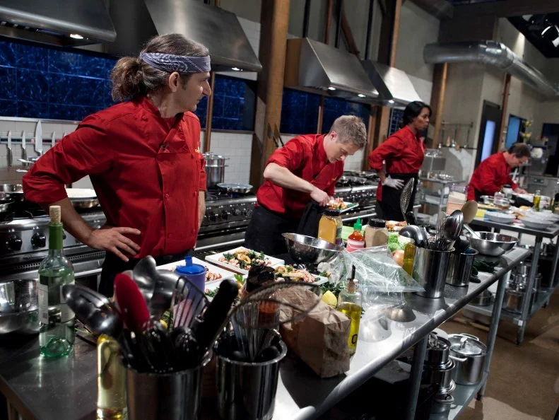Celebrities: Michael Imperioli, Lucas Grabeel, Tasha Smith and Peter Scolari working on their appetizers that must include: squid, dinosaur kale, popcorn on the cob and candy blood, as seen on Food Networkâ  s Chopped, Season 19.