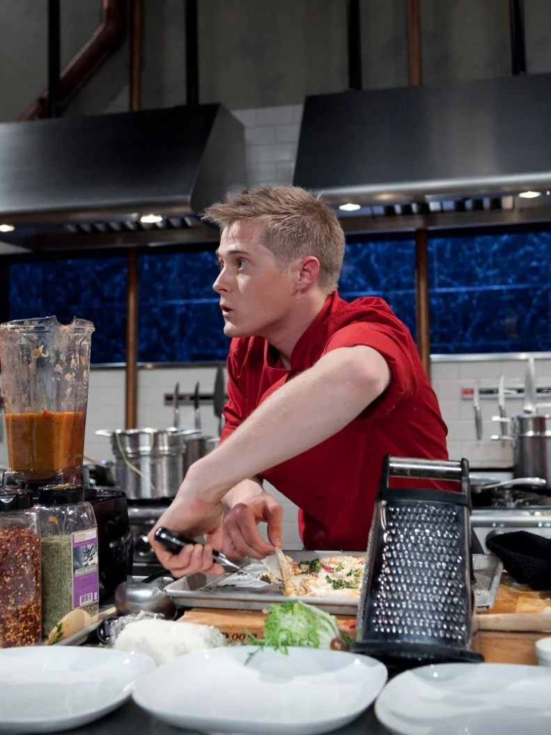 Celebrity Lucas Grabeel working on his entree that must include: spiny lobster, pink variegated lemons, amaro and radish, as seen on Food Networkâ  s Chopped, Season 19.