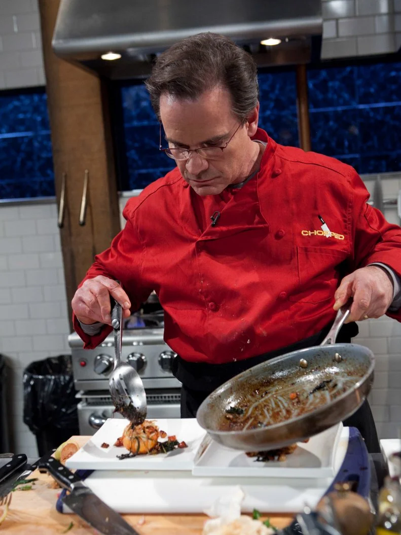 Celebrity Peter Scolari working on his entree that must include: spiny lobster, pink variegated lemons, amaro and radish, as seen on Food Networkâ  s Chopped, Season 19.