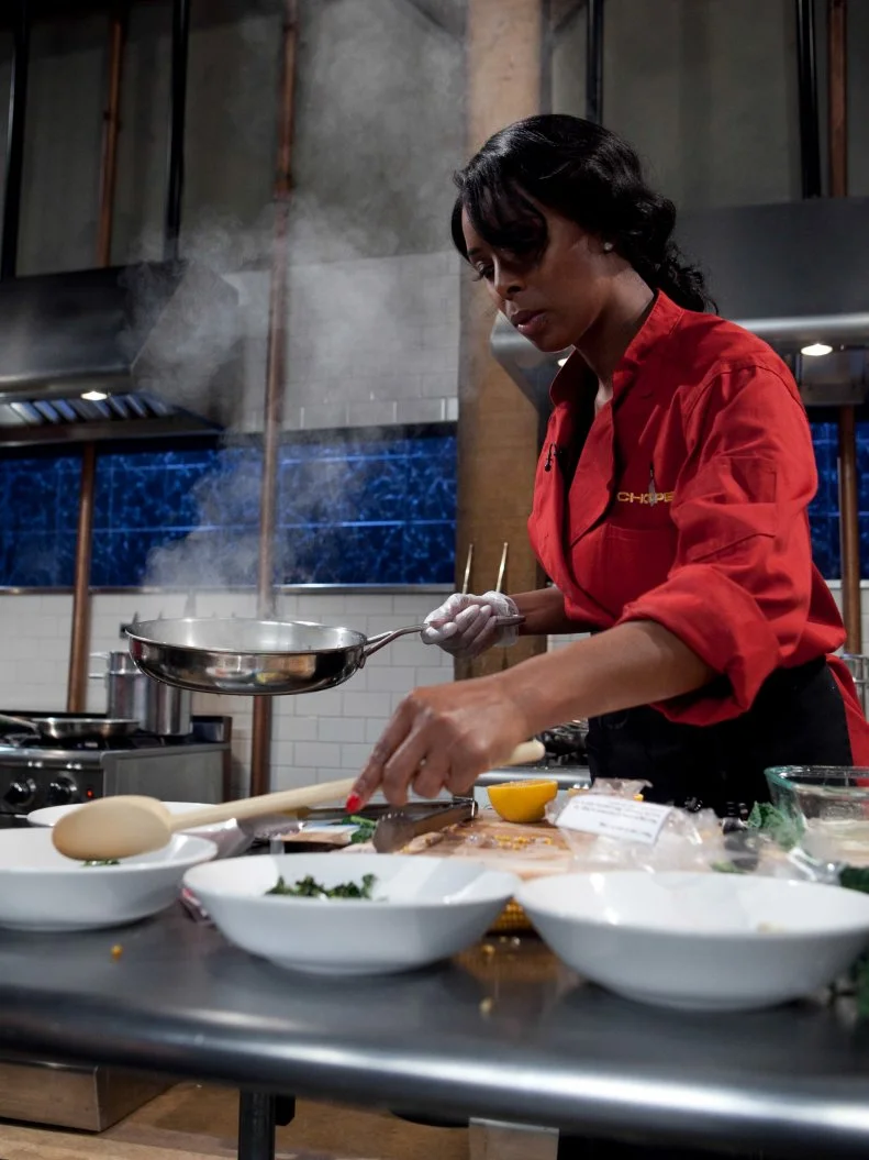 Celebrity Tasha Smith working on her appetizer that must include: squid, dinosaur kale, popcorn on the cob and candy blood, as seen on Food Networkâ  s Chopped, Season 19.