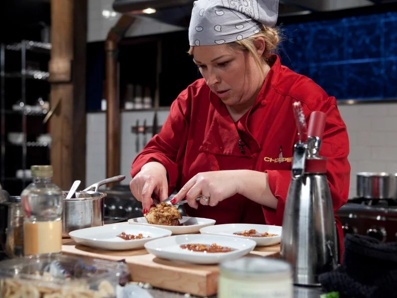 Celebrity Carnie Wilson working on her dessert that must include: peanut and caramel chocolate bar, chinese five spice, coconut milk, banana chips, as seen on Food Network's Chopped, Season 19.
