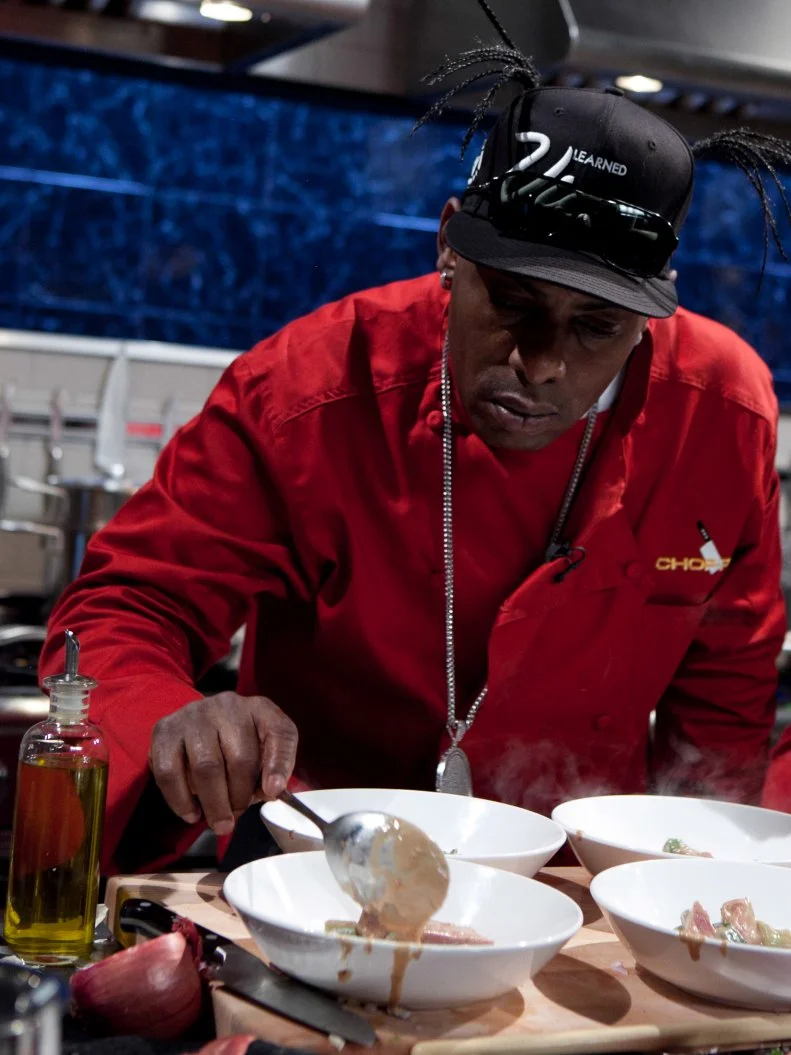 Celebrity Coolio working on his appetizer that must include: beef tongue, candies citron, Chinese broccoli and microwave chocolate cake, as seen on Food Networkâ  s Chopped, Season 19