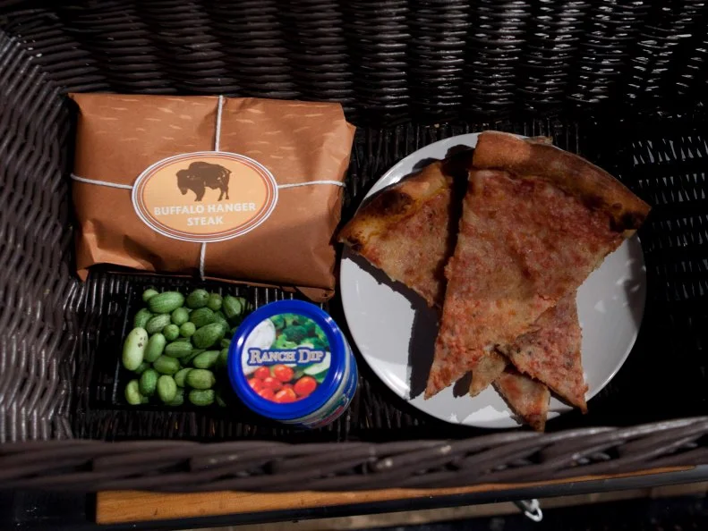 The mystery basket ingredients for the entree round are: buffalo hanger steak, watermelon cucumbers, ranch dip, pizza, as seen on Food Network's Chopped, Season 19.