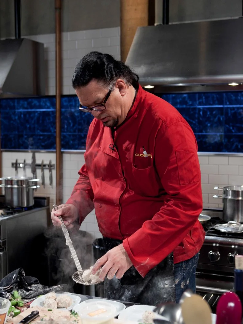 Celebrity Penn Jillette  working on his appetizer that must include: beef tongue, candies citron, Chinese broccoli and microwave chocolate cake, as seen on Food Networkâ  s Chopped, Season 19