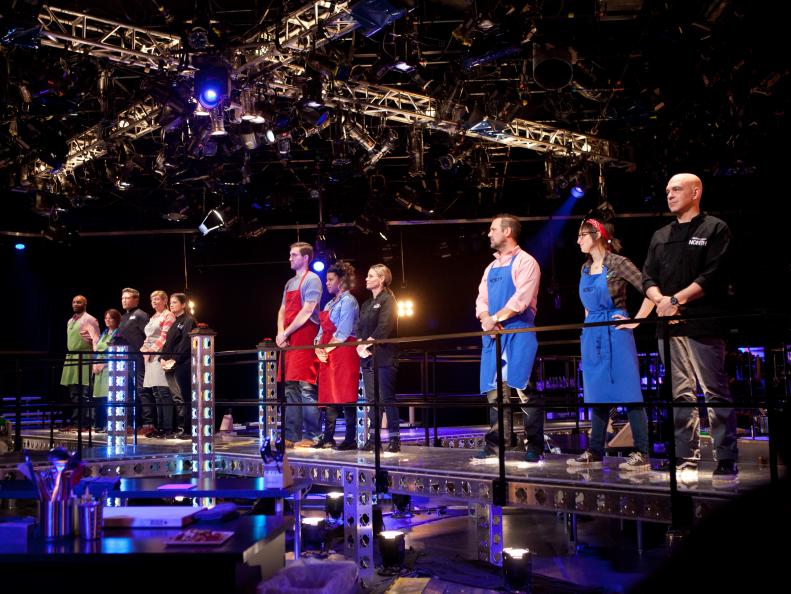 Down to seven remaining contestants, cooks and chefs line up on the catwalk before the beginning of the third round, as seen on Food Network's America's Best Cook, Season 1.