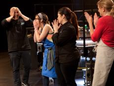 Cook Stephanie Goldfarb, second from left, reacts as guest judge Chef Bobby Flay (off camera) declares her the season's winner, as seen on Food Network's America's Best Cook, Season 1.