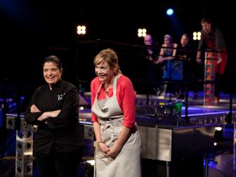 Cook Christine Verrelli, right, and Chef Alex Guarnaschelli, left, react during the judging of the seventh round of competition, as seen on Food Network's America's Best Cook, Season 1.