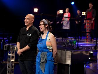 Cook Stephanie Goldfarb and Chef Michael Symon react to guest judge Chef Bobby Flay's comments during the judging of the seventh round of competition, as seen on Food Network's America's Best Cook, Season 1.