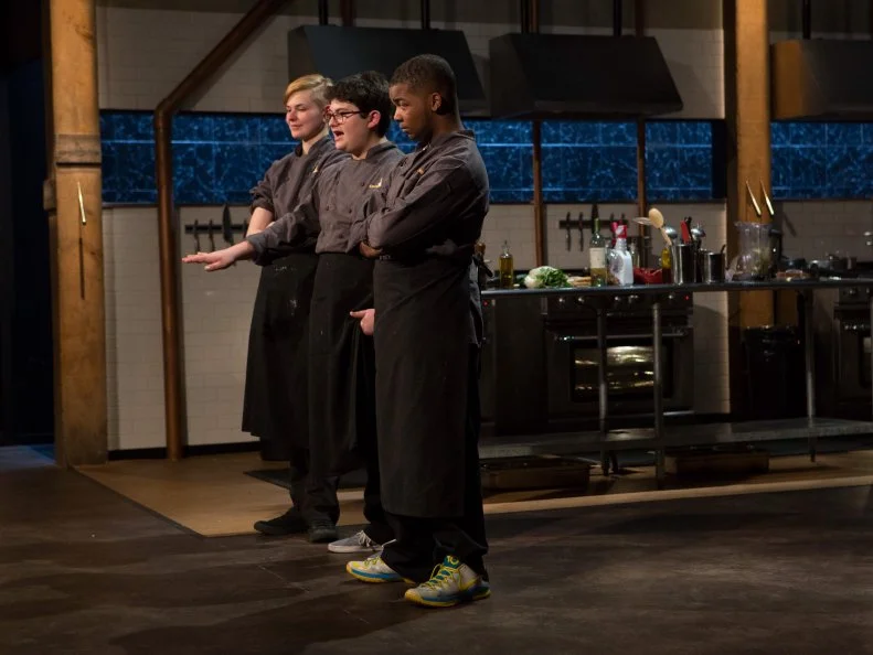 Teen competitors (L-R) Lucy Felong (15), Eyan Goldman (16) and Dante Foggy (17) stand before Chopped host Ted Allen and judges: Geoffrey Zakarian, Amanda Freitag and Marc Murphy waiting to be judged on their entrees that must have included:frogs legs, mafaldine, bok choy and lobster mushrooms, as seen on Food Network's Chopped, Season 21.