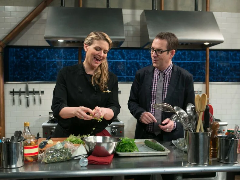 After Hours host Ted Allen checks in on chef Amanda Freitag while she works on her dish that must include: cherry drink soaked pickles, lamb chops, kale chips and ricotta salata, as seen on Food Network's Chopped After Hours, season 21.