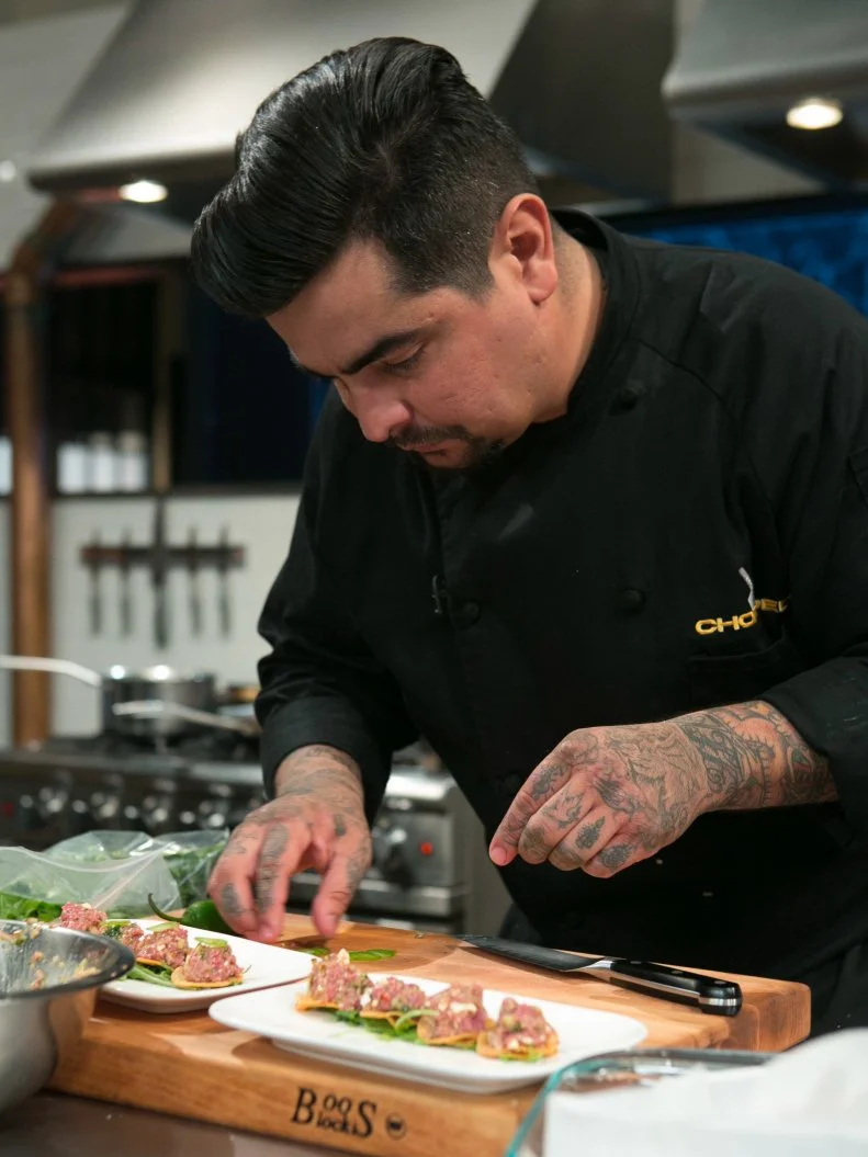 Chef Aaron Sanchez while working on his dish that must include:cherry drink soaked pickles, lamb chops, kale chips and ricotta salata, as seen on Food Network's Chopped After Hours, season 21.