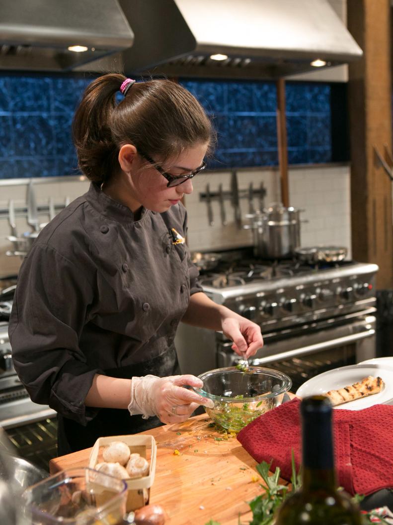 Teen Competitor Hannah Bukzin (14) works on her appetizer that must include: rabbit and ginger sausage, dandelion greens, dried currants and hot sauce candy canes as she competes for a slot in the Teen Challenge and a chance to win $25,000 and a $40,000 culinary school scholarship, as seen on Food Network's Chopped, season 21.