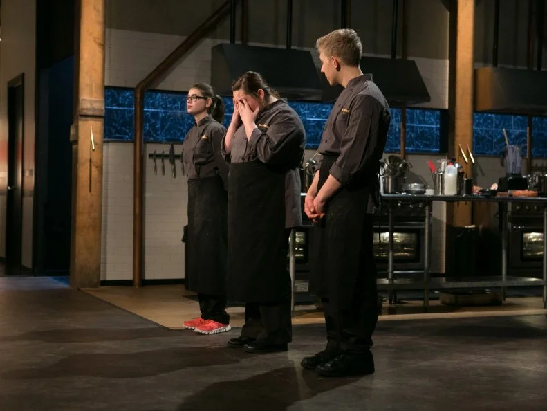 Teen Competitors: Hannah Bukzin (14), Tommi Rae Fowler (16)  and Max Aronson react to host Ted Allen and judges: Chris Santos, Alex Guarnaschelli and Alex Stupakto and defend their entrees that must include: pineapple upside-down cake, cornish hens, hen of the woods mushrooms and edamame hummus  as they compete for a slot in the Teen Challenge and a chance to win $25,000 and a $40,000 culinary school scholarship, as seen on Food Network's Chopped, season 21.