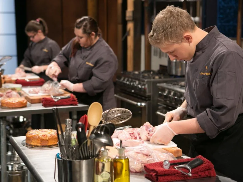 Teen Competitors: Hannah Bukzin (14), Tommi Rae Fowler (16)  and Max Aronson (16)working on their entrees that must include: pineapple upside-down cake, cornish hens, hen of the woods mushrooms and edamame hummus  as they compete for a slot in the Teen Challenge and a chance to win $25,000 and a $40,000 culinary school scholarship, as seen on Food Network's Chopped, season 21.