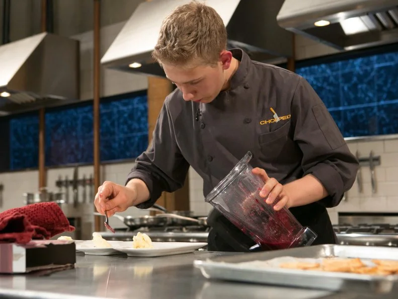Teen competitor Max Aronson (16)  works on his dessert that must include: chocolate fudge, cinnamon cereal , pie crust and grape-flavored carbonated candy as he competes for a slot in the Teen Challenge and a chance to win $25,000 and a $40,000 culinary school scholarship, as seen on Food Network's Chopped, season 21.