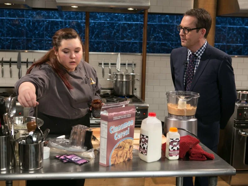 Chopped host Ted Allen checks in with teen competitor Tommi Rae Fowler (16) as she  works on her dessert that must include: chocolate fudge, cinnamon cereal , pie crust and grape-flavored carbonated candy as she competes for a slot in the Teen Challenge and a chance to win $25,000 and a $40,000 culinary school scholarship, as seen on Food Network's Chopped, season 21.