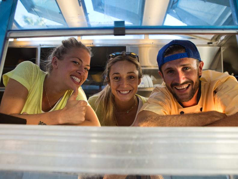 The Beach Cruiser food truck team of Nicole Hofman, Gretta Kruesi, and Shane Steinman takes a moment to pose for a photo inside their truck parked Abbott Kinney Blvd., as seen on Food Network's The Great Food Truck Race, Season 5.