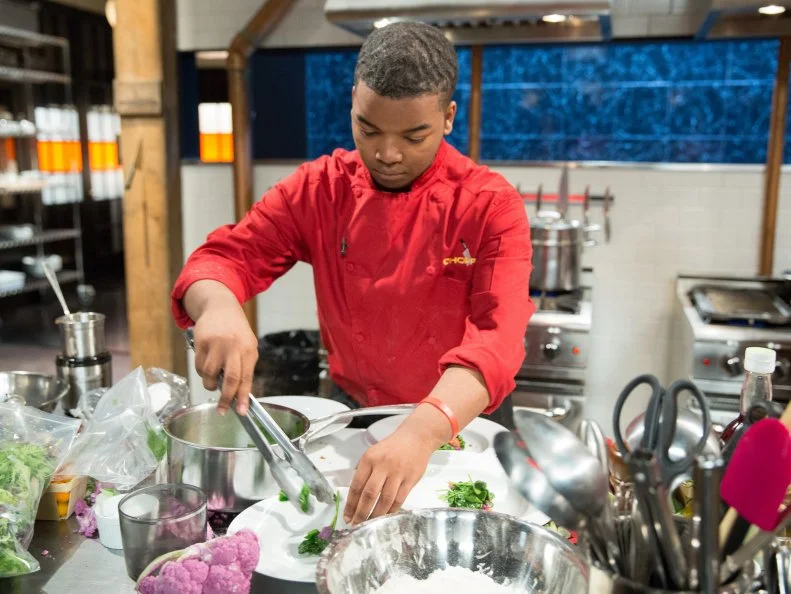 Teen competitor Dante Foggy cooks during a competition, as seen on Food Networkâ  s Chopped, Season 21.