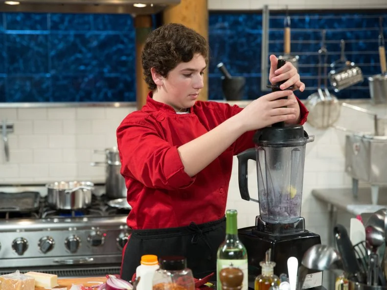 Teen competitor Jason Khaytin cooking during a competition, as seen on Food Networkâ  s Chopped, Season 21.